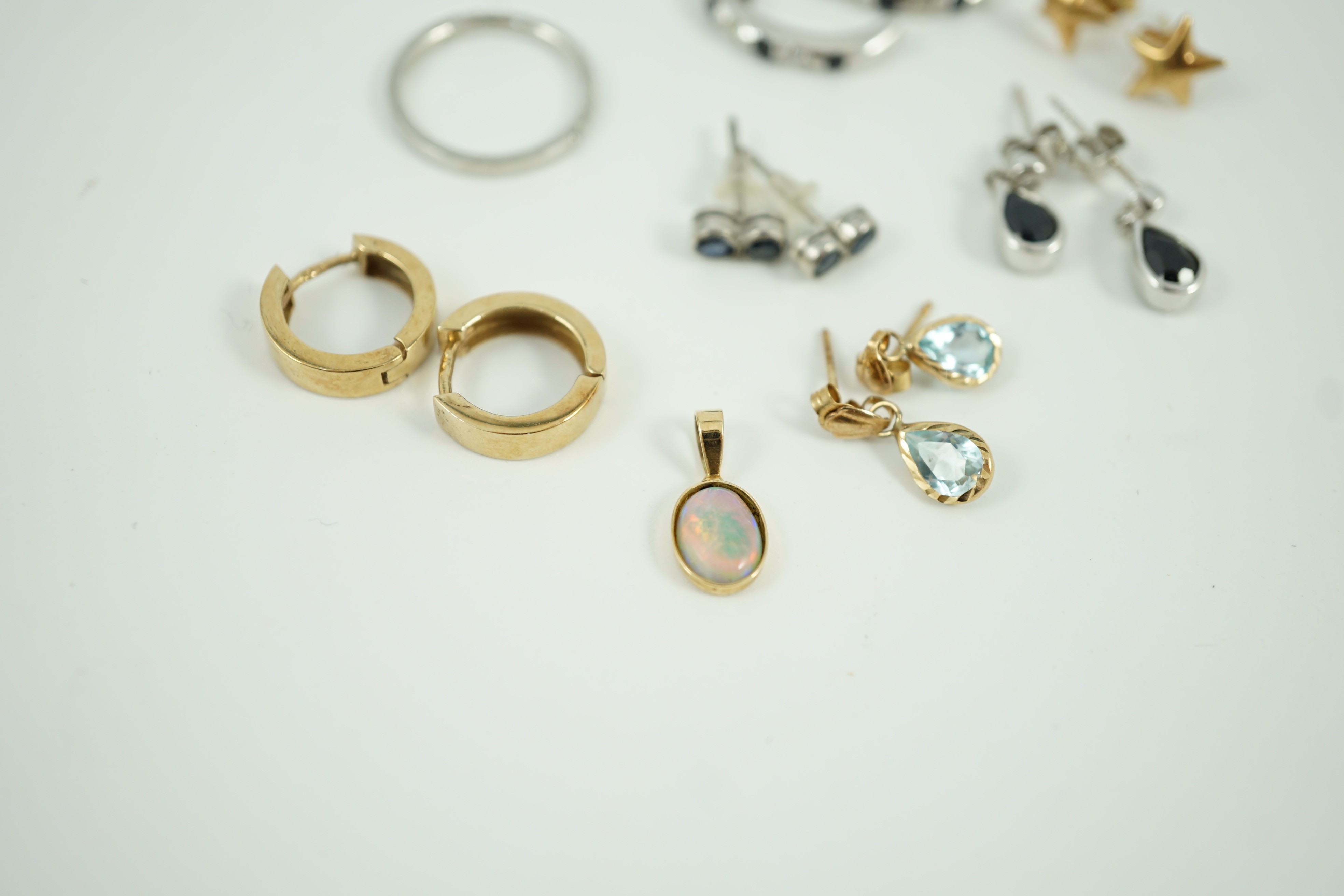 Three assorted modern 9ct earrings including sapphire and diamond chip set half hoop, gross 6.3 grams, three other white or yellow metal pairs, gross 2.6 grams, a small 14k and white opal doublet? set pendant, gross 0.5